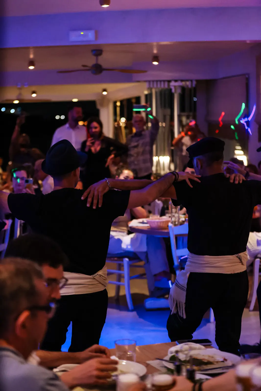 The line moves through the room at Blue Myth, arms over shoulders
